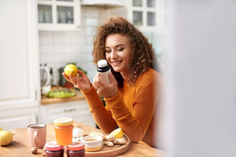 Woman holding a bottle of vitamins